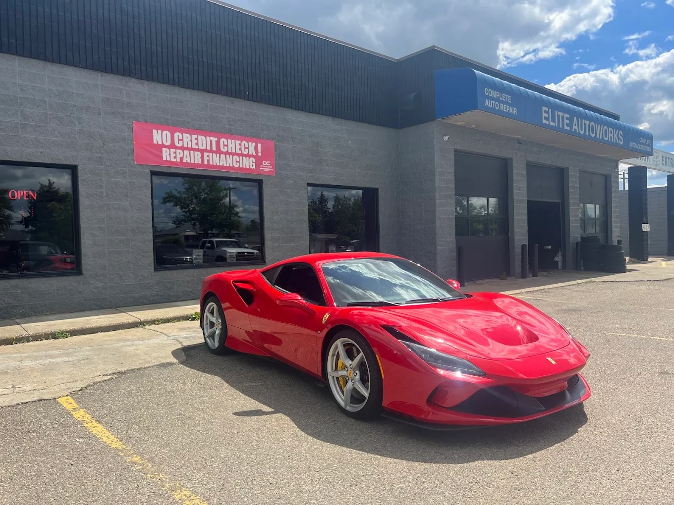 Red sports car outside the Elite Autoworks shop