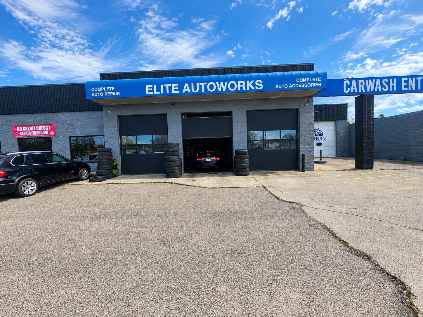 Elite Autoworks building on 156 St NW with a bay door open