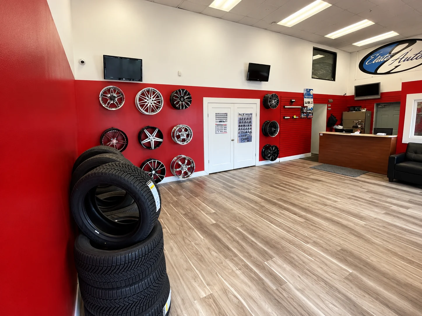 Showroom with tires and wheels on a red feature wall